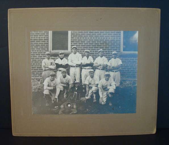 Early Base Ball Team in Front of Brick Building with Equipment